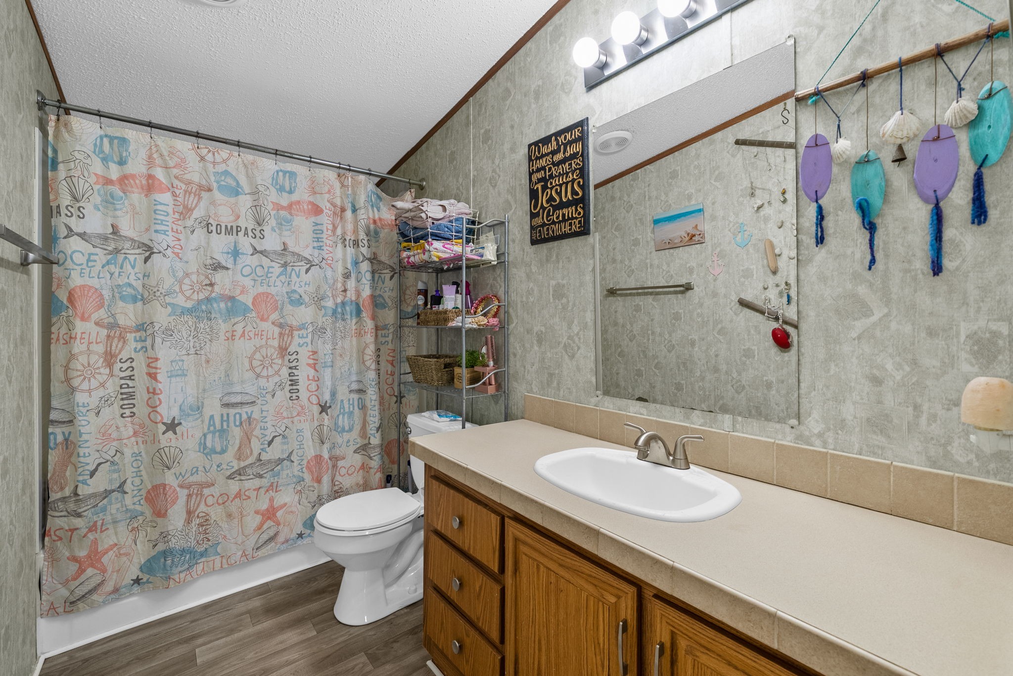 197 Old Homestead Road Big Sandy, TN 38221 - Photo 27 of 59 a bathroom with a sink toilet and shower