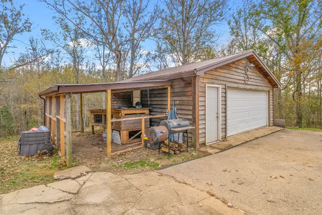 a backyard of a house with table and chairs