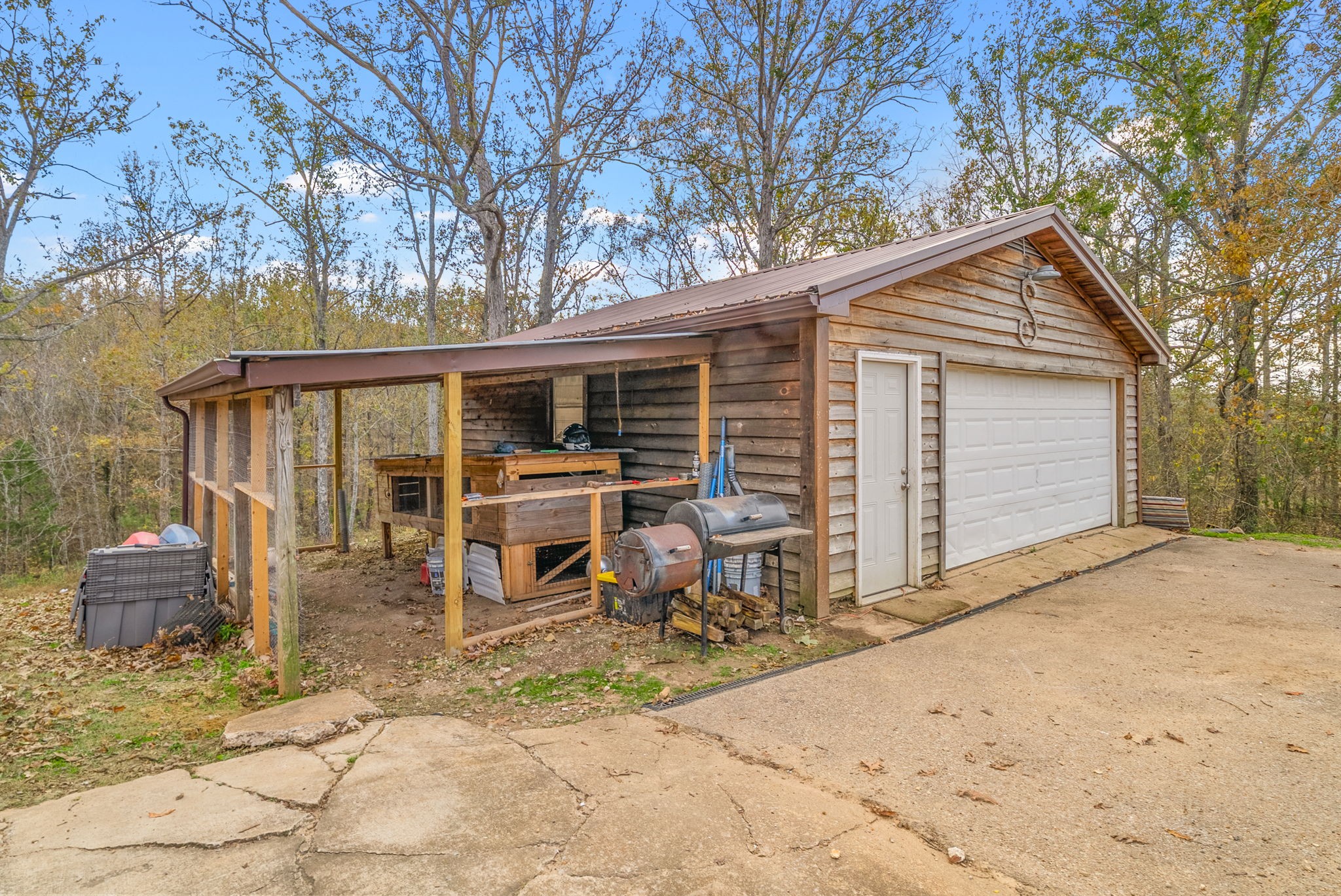 197 Old Homestead Road Big Sandy, TN 38221 - Photo 34 of 59 a backyard of a house with table and chairs