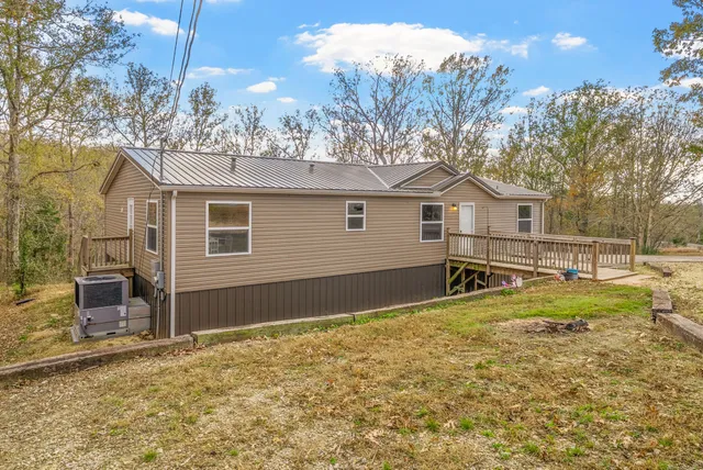 a view of a house with a yard and wooden fence
