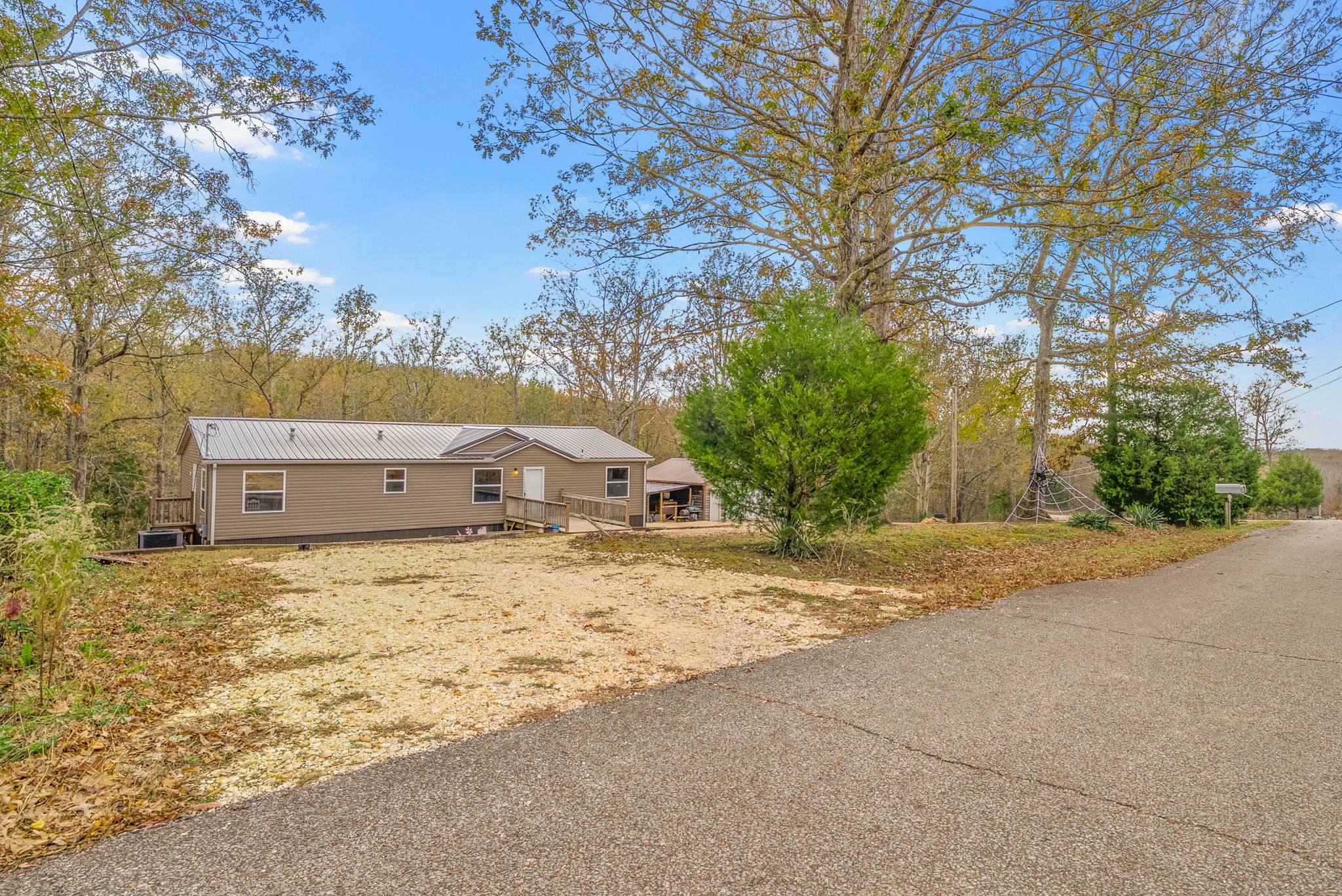197 Old Homestead Road Big Sandy, TN 38221 - Photo 6 of 59 a big house with tree in front of it