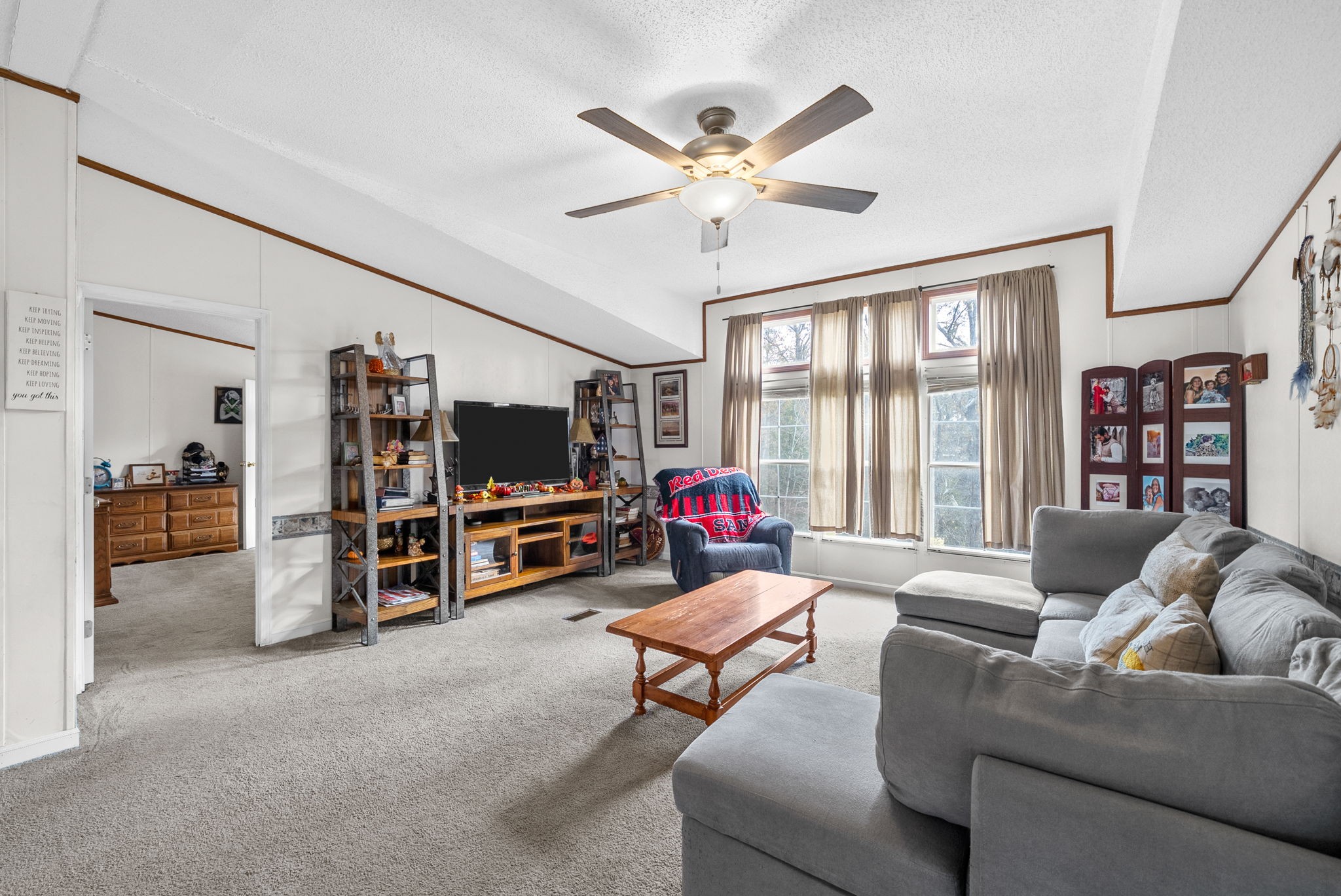 197 Old Homestead Road Big Sandy, TN 38221 - Photo 9 of 59 a living room with furniture and a flat screen tv