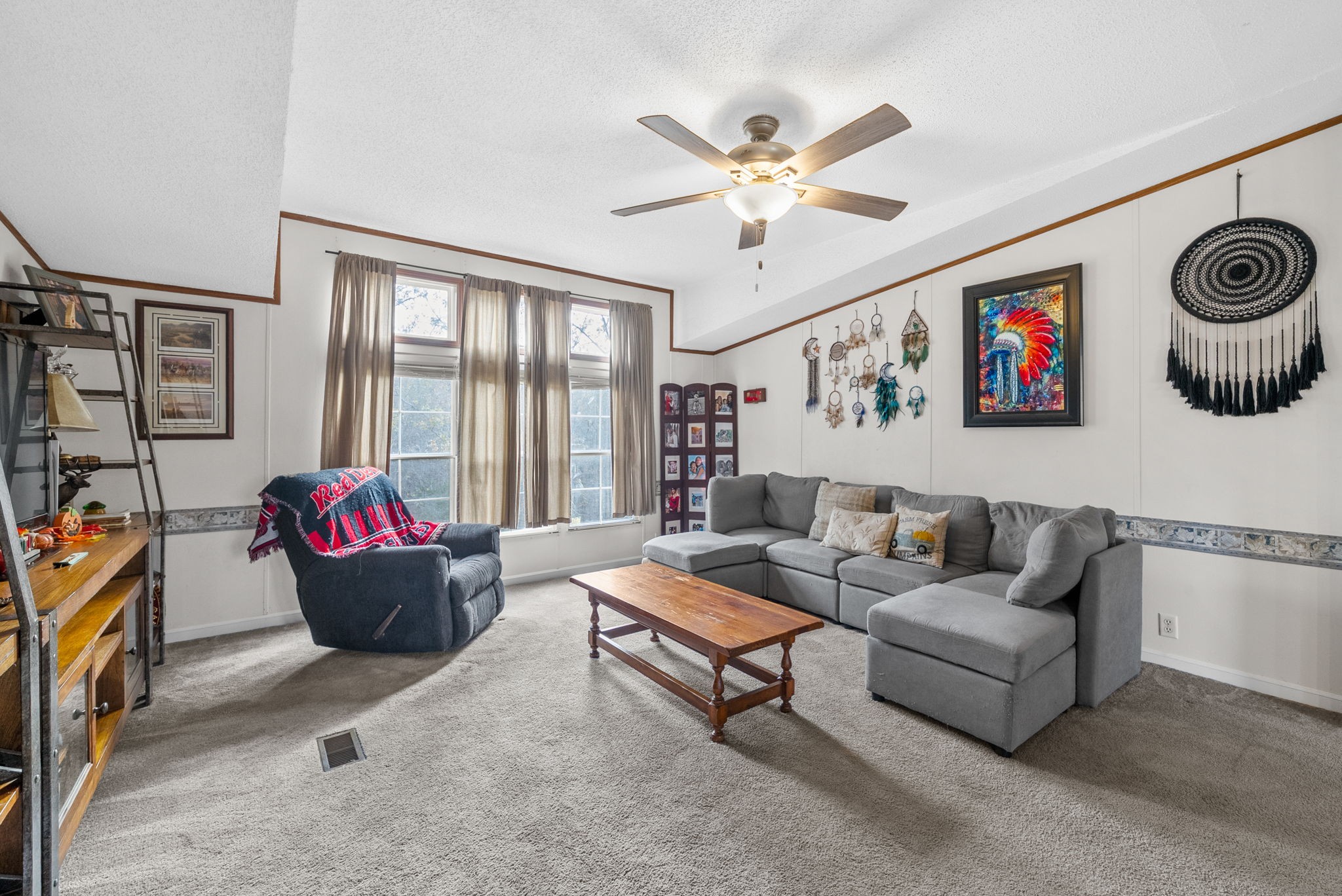 197 Old Homestead Road Big Sandy, TN 38221 - Photo 10 of 59 a living room with furniture and a flat screen tv