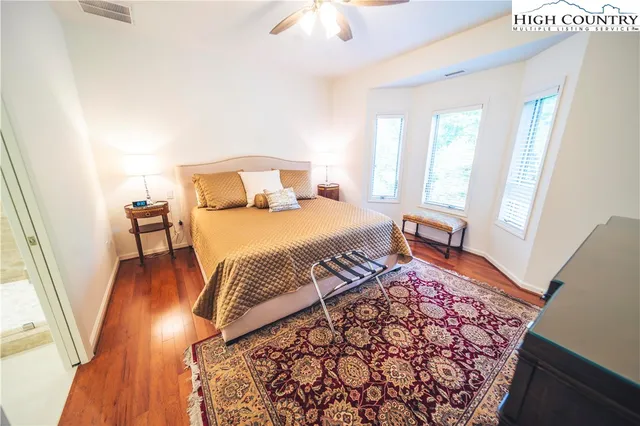 a bedroom with a bed and a mirror on dresser