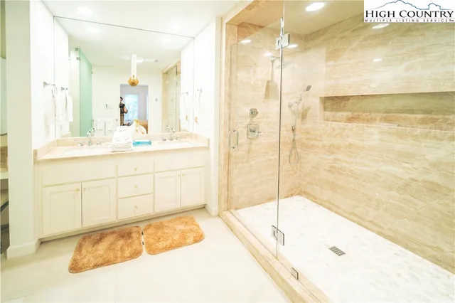 a bathroom with a tub sink and shower