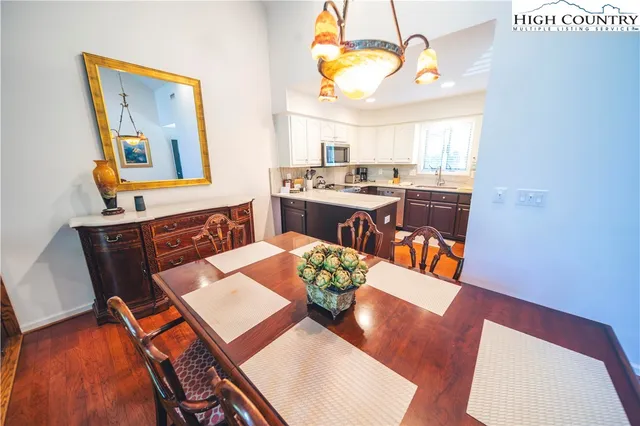 a view of a dining room with furniture wooden floor and a chandelier