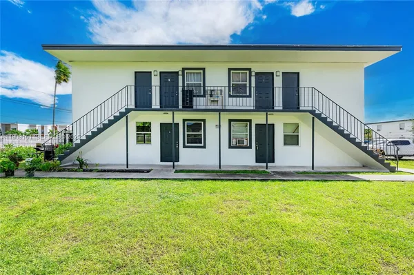 a view of a house with pool and sitting area