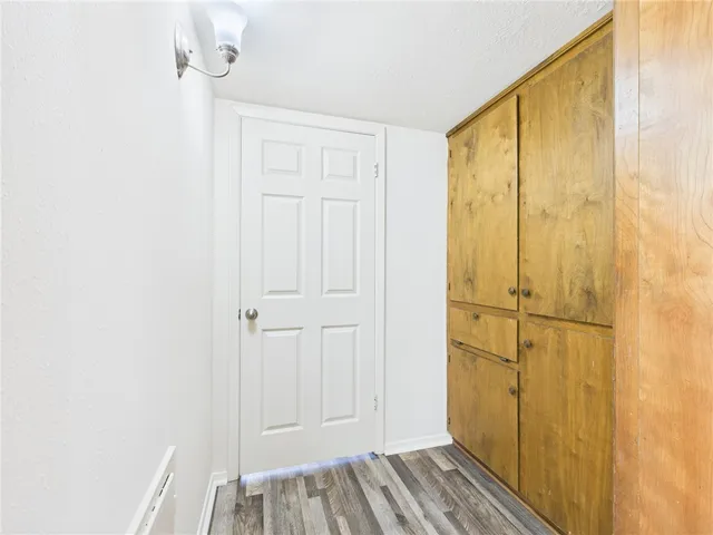 an empty room with a window and a ceiling fan