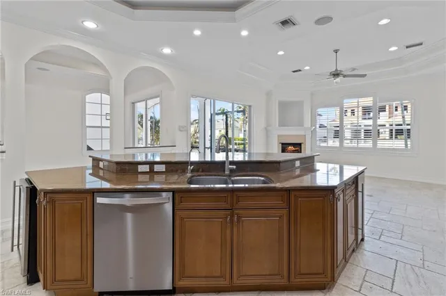 a view of an empty room with window and fire place