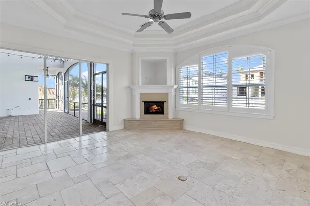 a view of a kitchen with refrigerator and a fireplace