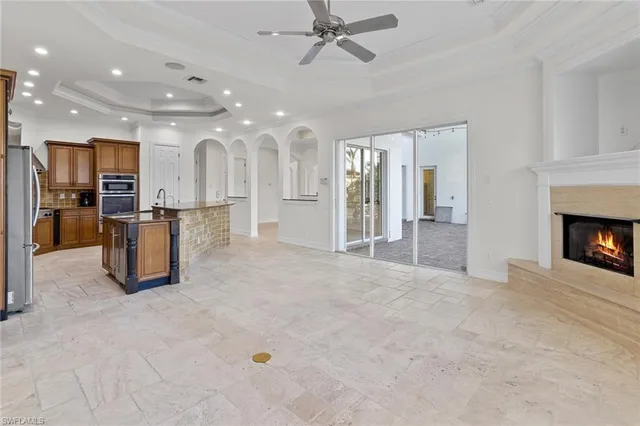 a kitchen with stainless steel appliances granite countertop a sink a stove and a refrigerator