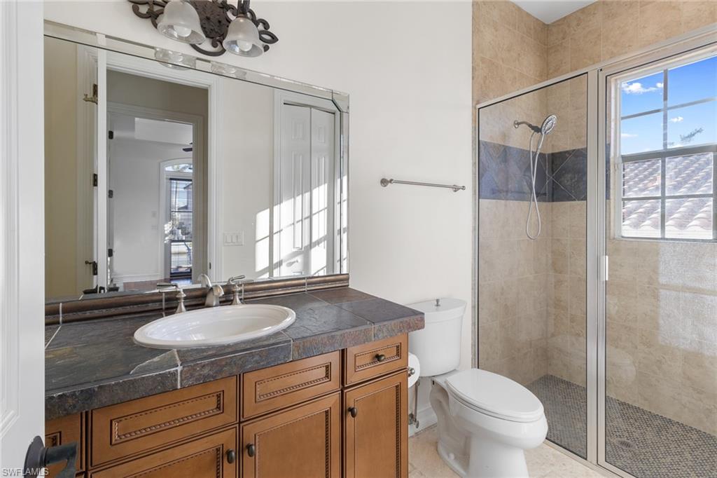 405 Trade Winds Avenue Naples, FL 34108 - Photo 23 of 48 a bathroom with a sink a toilet and shower