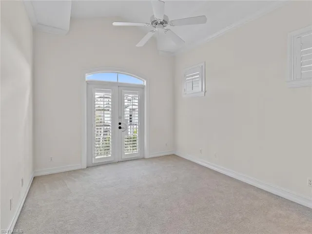 an empty room with chandelier fan