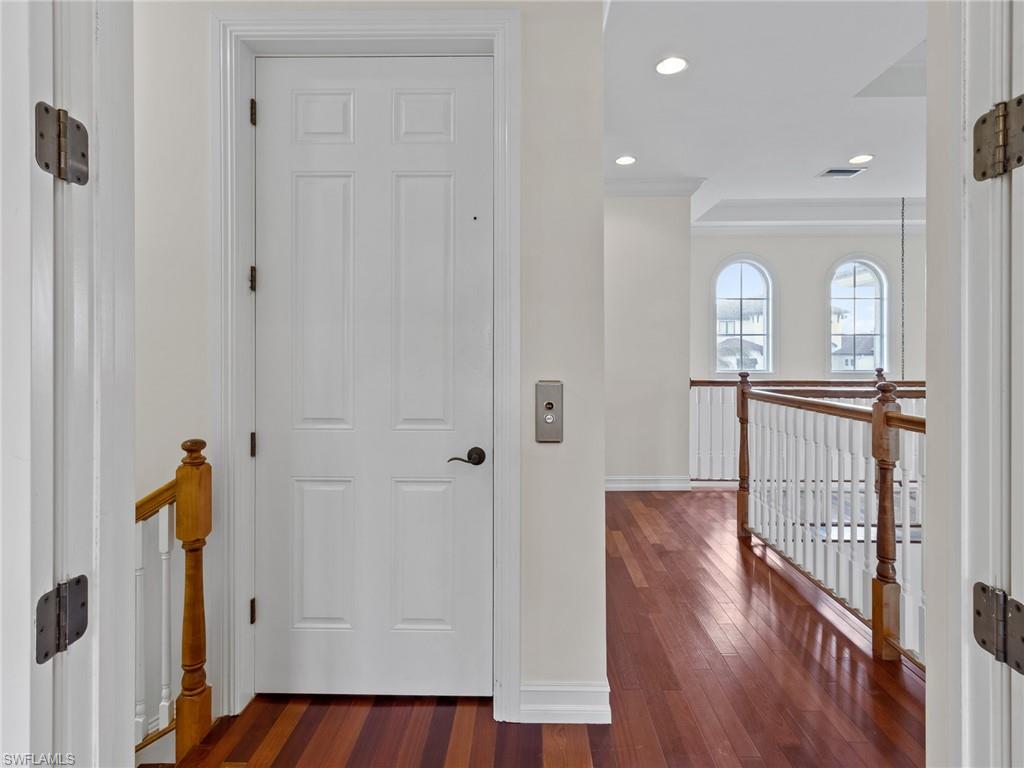 405 Trade Winds Avenue Naples, FL 34108 - Photo 26 of 48 a view of a hallway with wooden floor windows and entryway