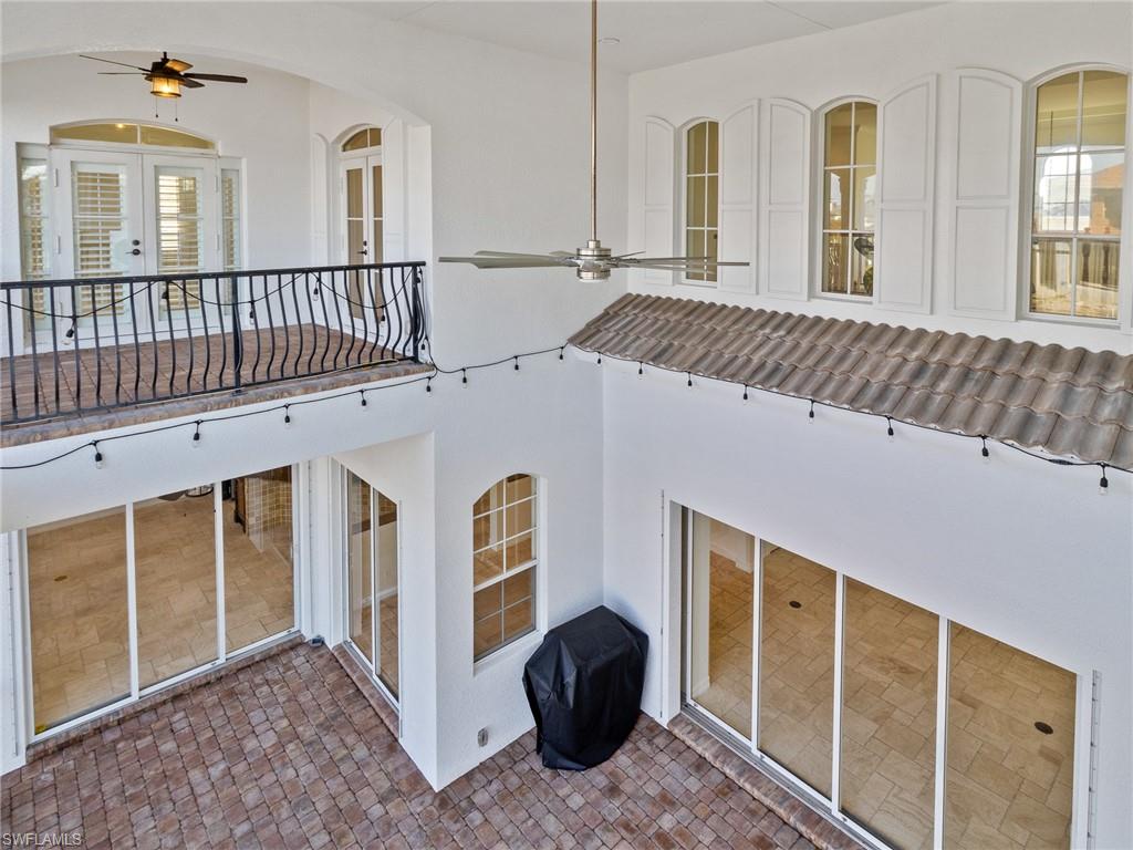 405 Trade Winds Avenue Naples, FL 34108 - Photo 28 of 48 a view of a porch with a table and chair