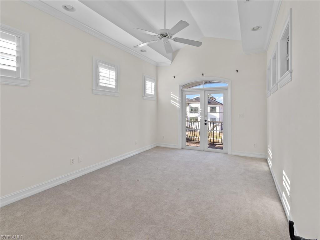 405 Trade Winds Avenue Naples, FL 34108 - Photo 30 of 48 en empty room with windows and ceiling fan
