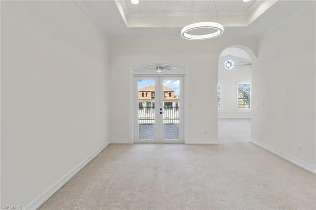 an empty room with windows and fireplace