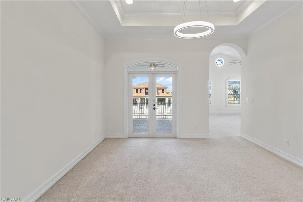 405 Trade Winds Avenue Naples, FL 34108 - Photo 34 of 48 an empty room with windows and mirror