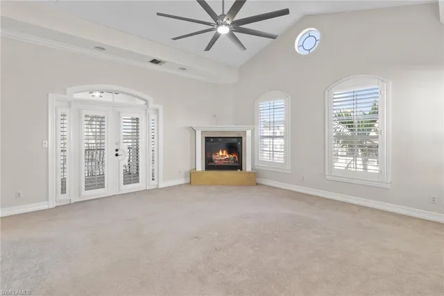 a view of an empty room with a fireplace and a window