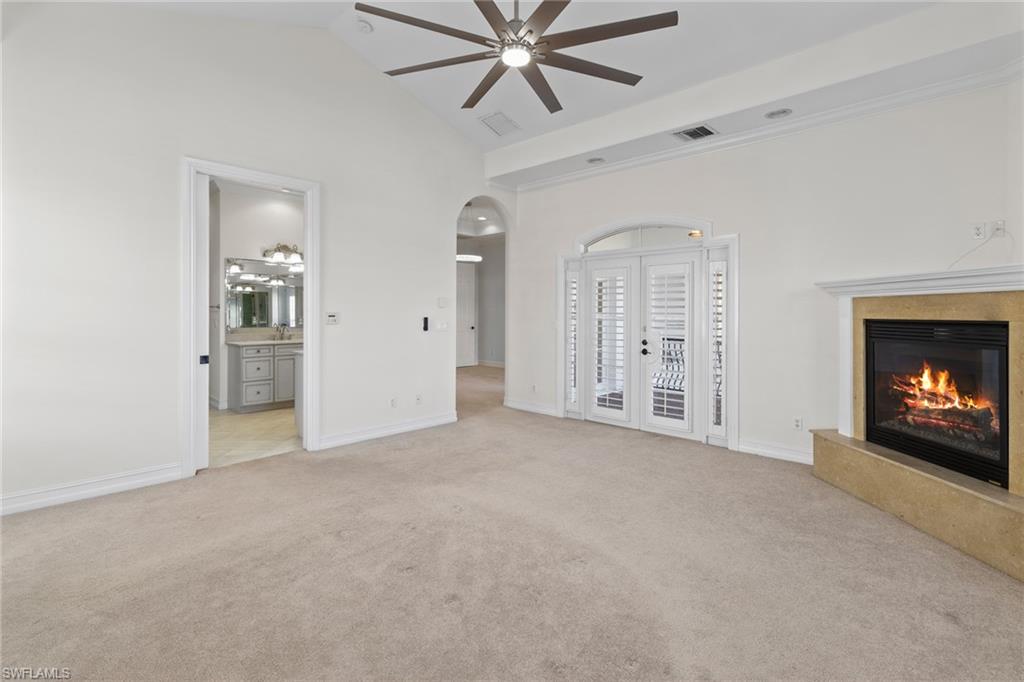 405 Trade Winds Avenue Naples, FL 34108 - Photo 36 of 48 a view of an empty room with a fireplace and a window