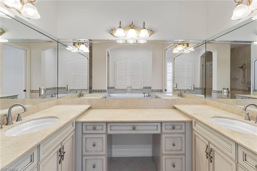 405 Trade Winds Avenue Naples, FL 34108 - Photo 38 of 48 a bathroom with a sink double vanity and a mirror