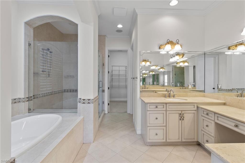 405 Trade Winds Avenue Naples, FL 34108 - Photo 39 of 48 a spacious bathroom with a granite countertop sink a toilet a bathtub and shower