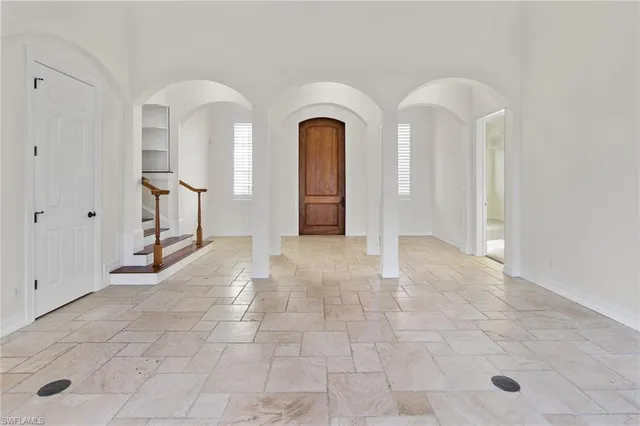 a view of a hallway with wooden floor and entryway