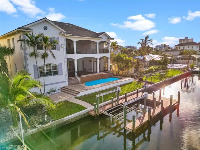 a front view of a house with garden and plants