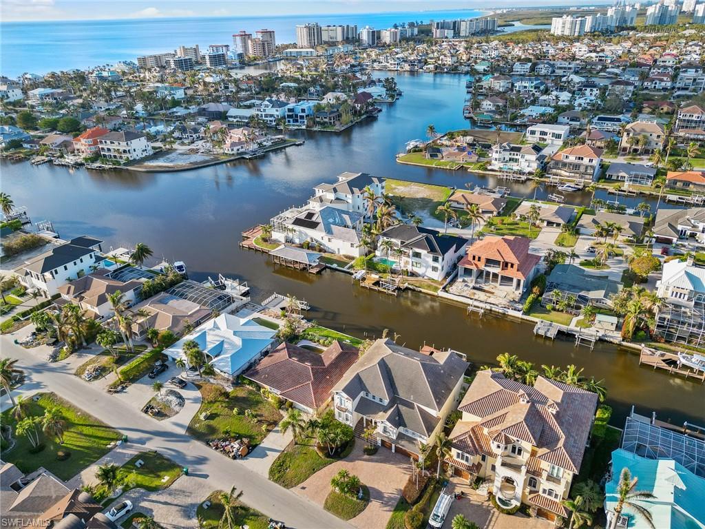 405 Trade Winds Avenue Naples, FL 34108 - Photo 47 of 48 an aerial view of a city with ocean view