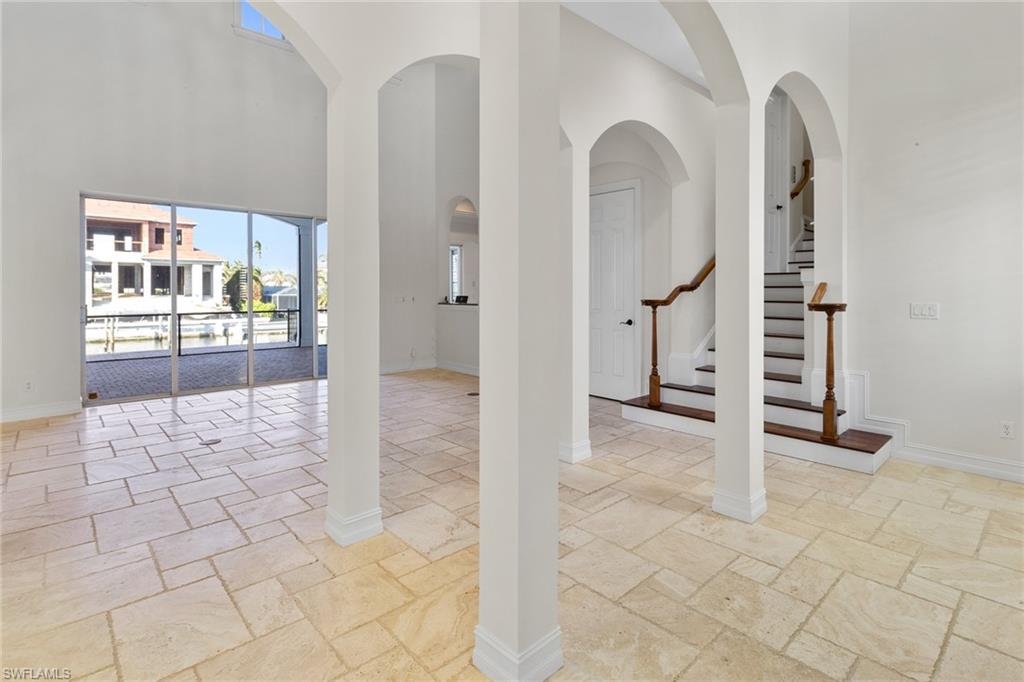 405 Trade Winds Avenue Naples, FL 34108 - Photo 5 of 48 a view of a hallway with wooden floor and entryway