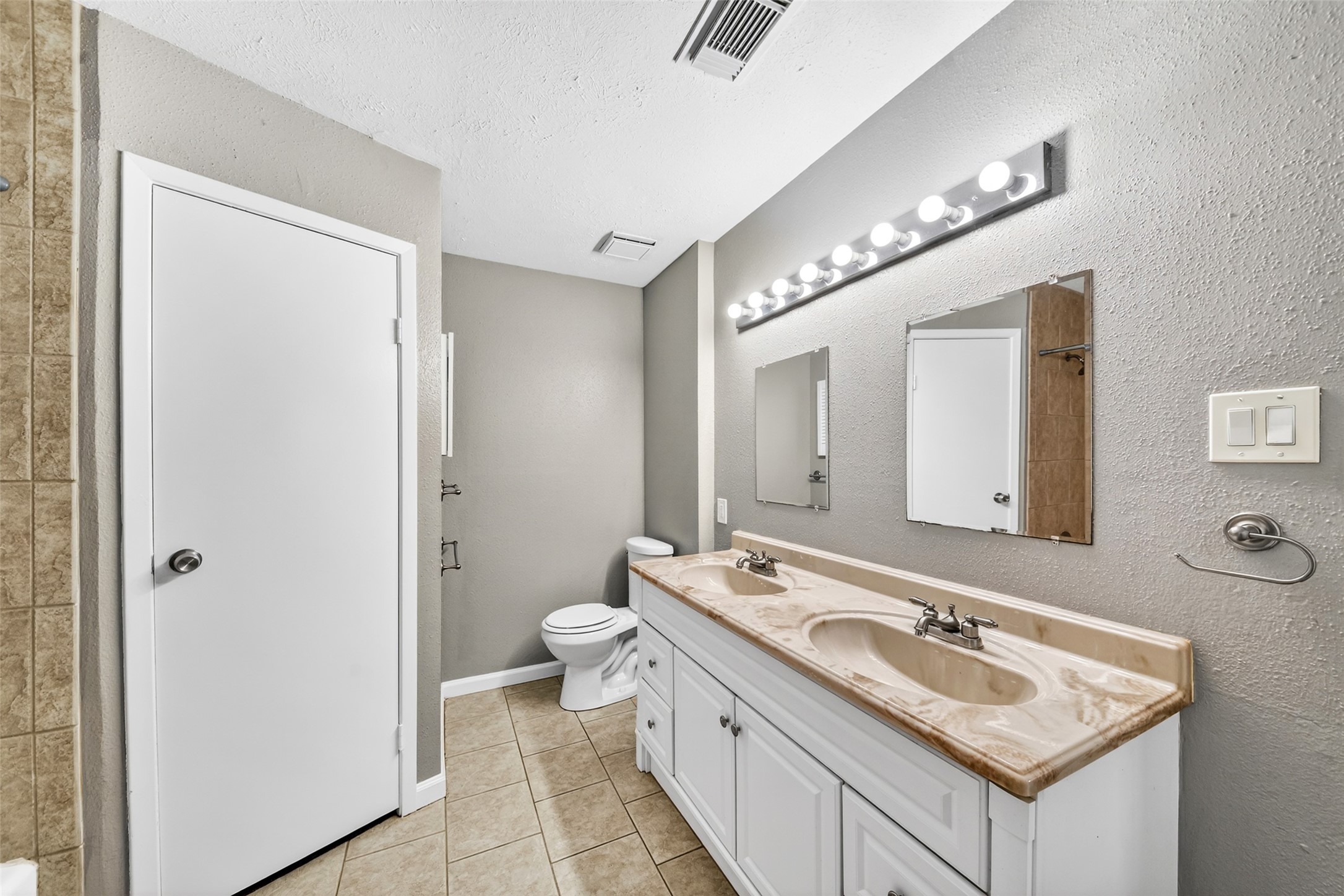 3119 Oak Rock Spring, TX 77373 - Photo 15 of 25 a bathroom with a granite countertop sink a toilet and a mirror