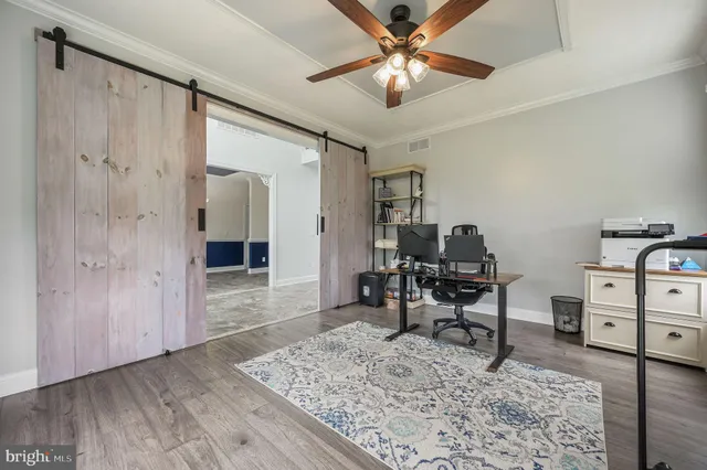 a workspace room with furniture