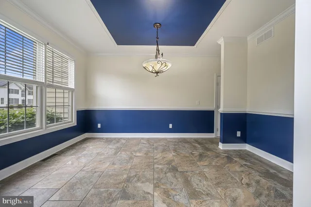 a view of a room with window a ceiling fan and windows