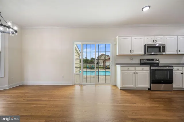 a kitchen with stainless steel appliances a stove top oven a sink and a refrigerator