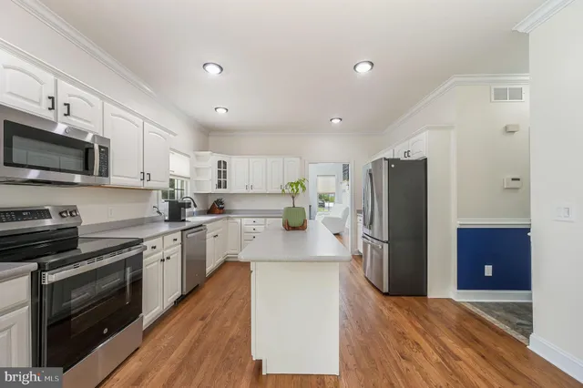 a kitchen with stainless steel appliances a refrigerator stove microwave and sink