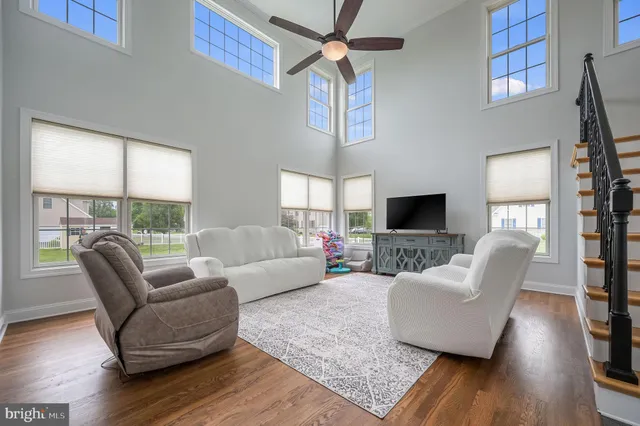 a living room with furniture wooden floor and a flat screen tv