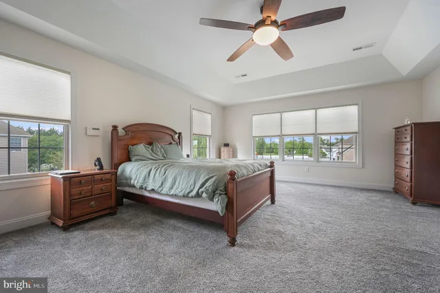 a bedroom with a bed dresser and a window