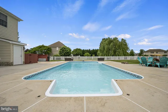 a view of a swimming pool with a yard
