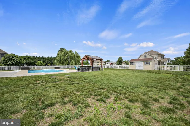 a view of green field with house in the background