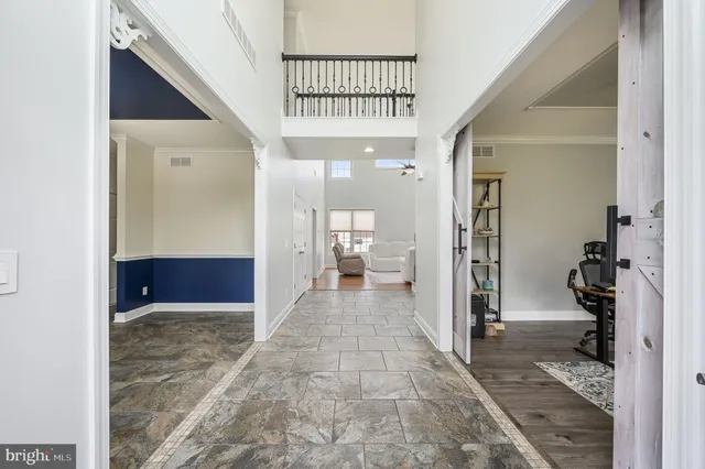 a view of a hallway with a livingroom and a bathroom
