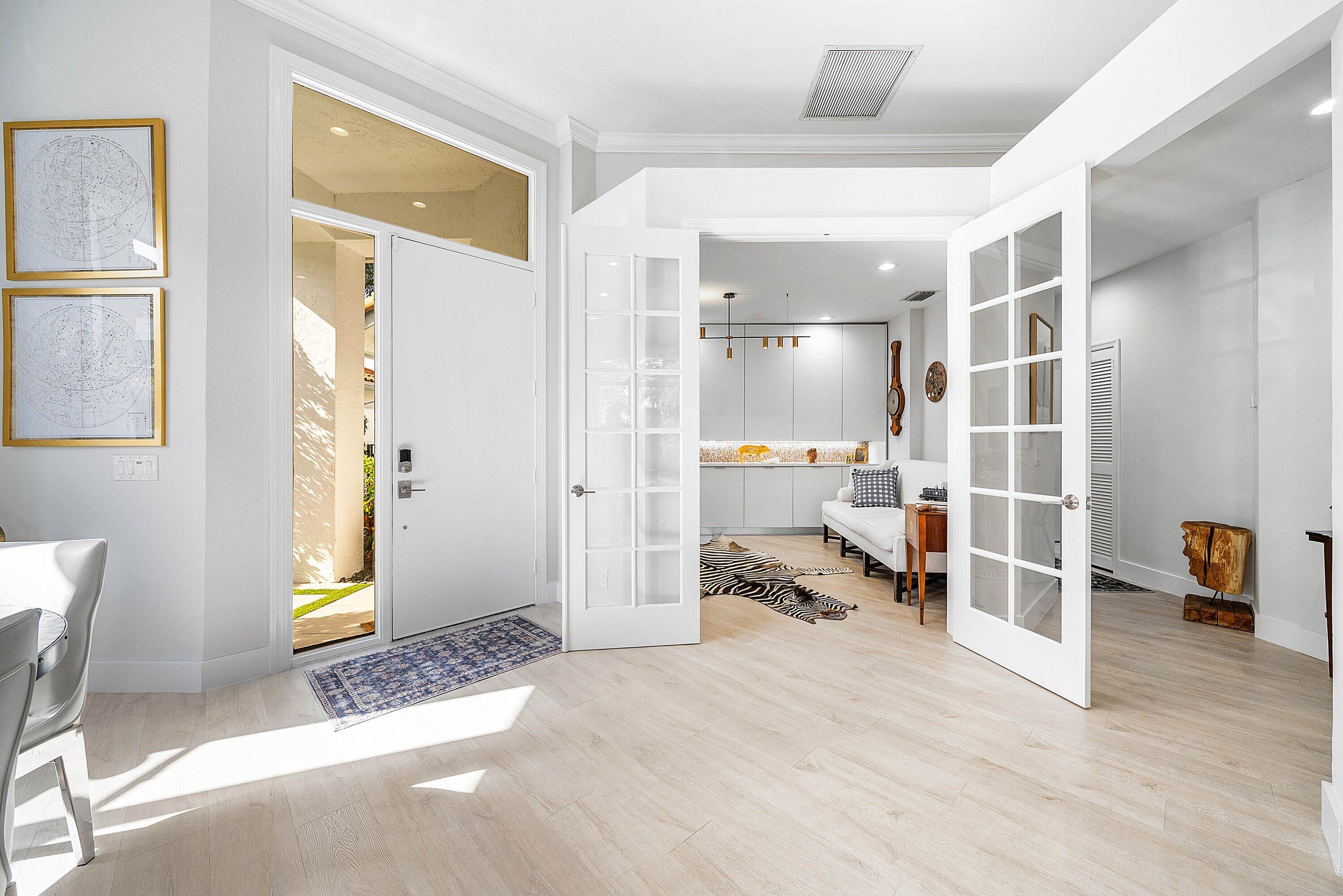 2224 Northwest 62nd Drive Boca Raton, FL 33496 - Photo 11 of 64 a view of a hallway with wooden floor and furniture
