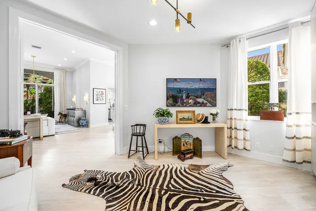a living room with furniture a wooden floor and dining table