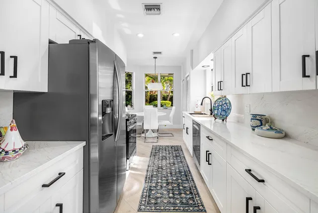 a kitchen with a sink cabinets and window