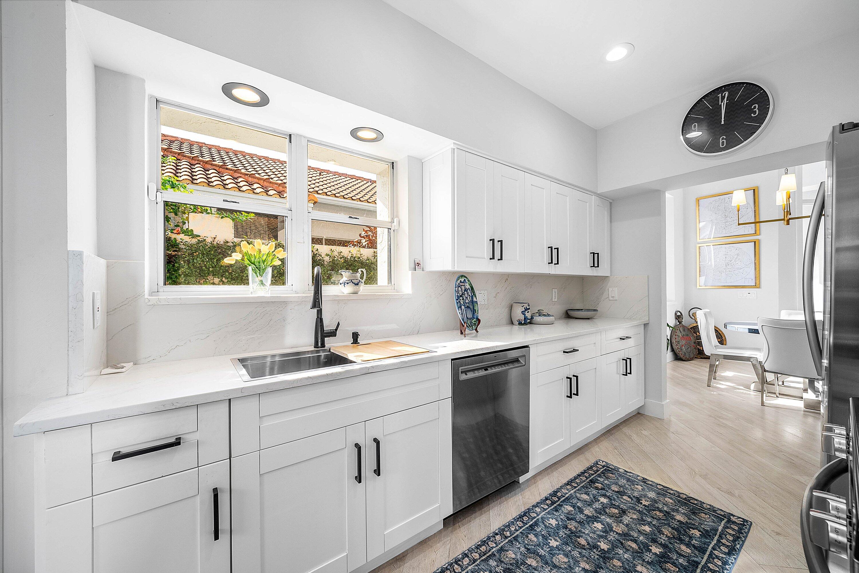 2224 Northwest 62nd Drive Boca Raton, FL 33496 - Photo 16 of 64 a kitchen with a sink cabinets and window