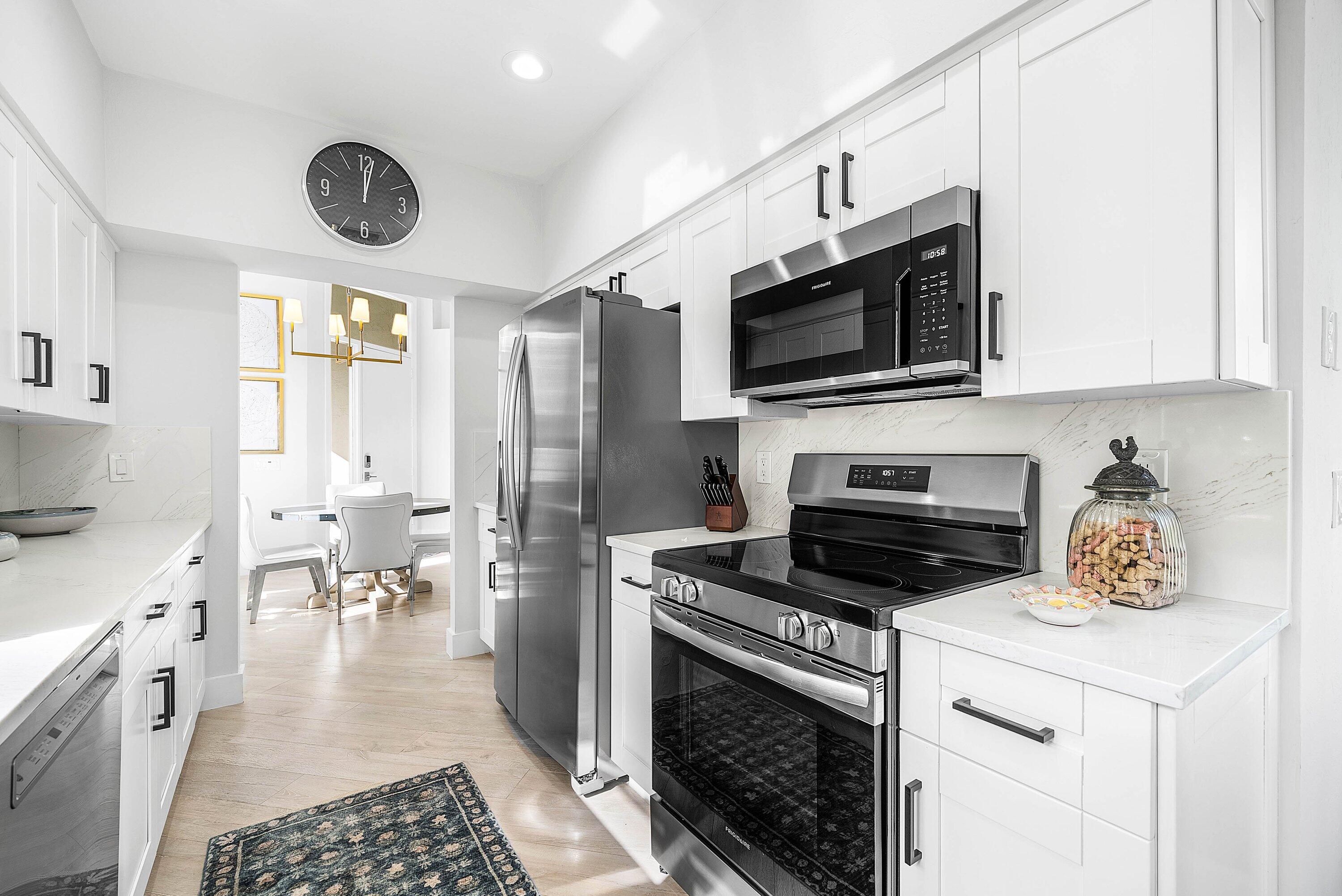 2224 Northwest 62nd Drive Boca Raton, FL 33496 - Photo 17 of 64 a kitchen with a stove a microwave and refrigerator