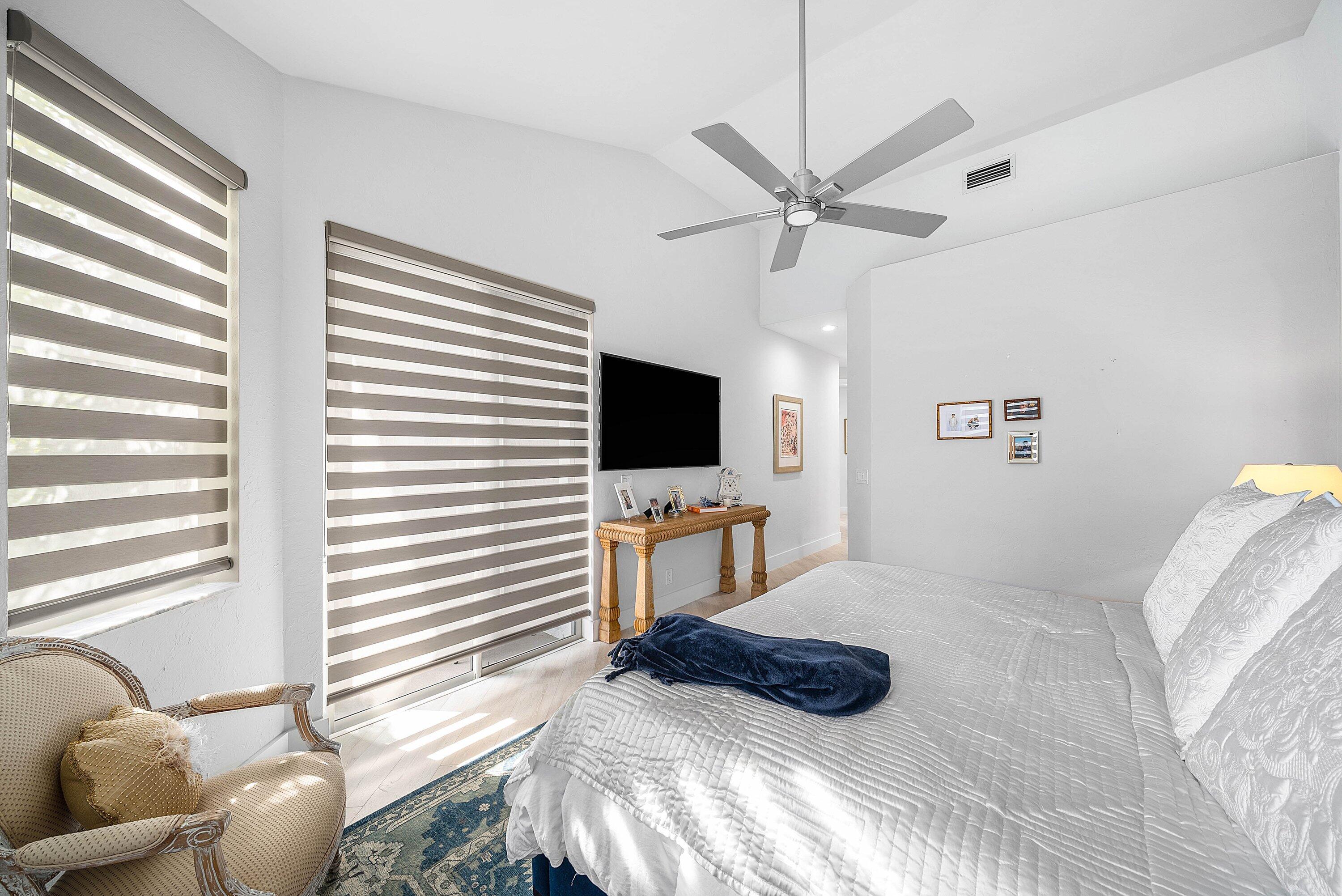 2224 Northwest 62nd Drive Boca Raton, FL 33496 - Photo 21 of 64 a bedroom with a bed and flat screen tv