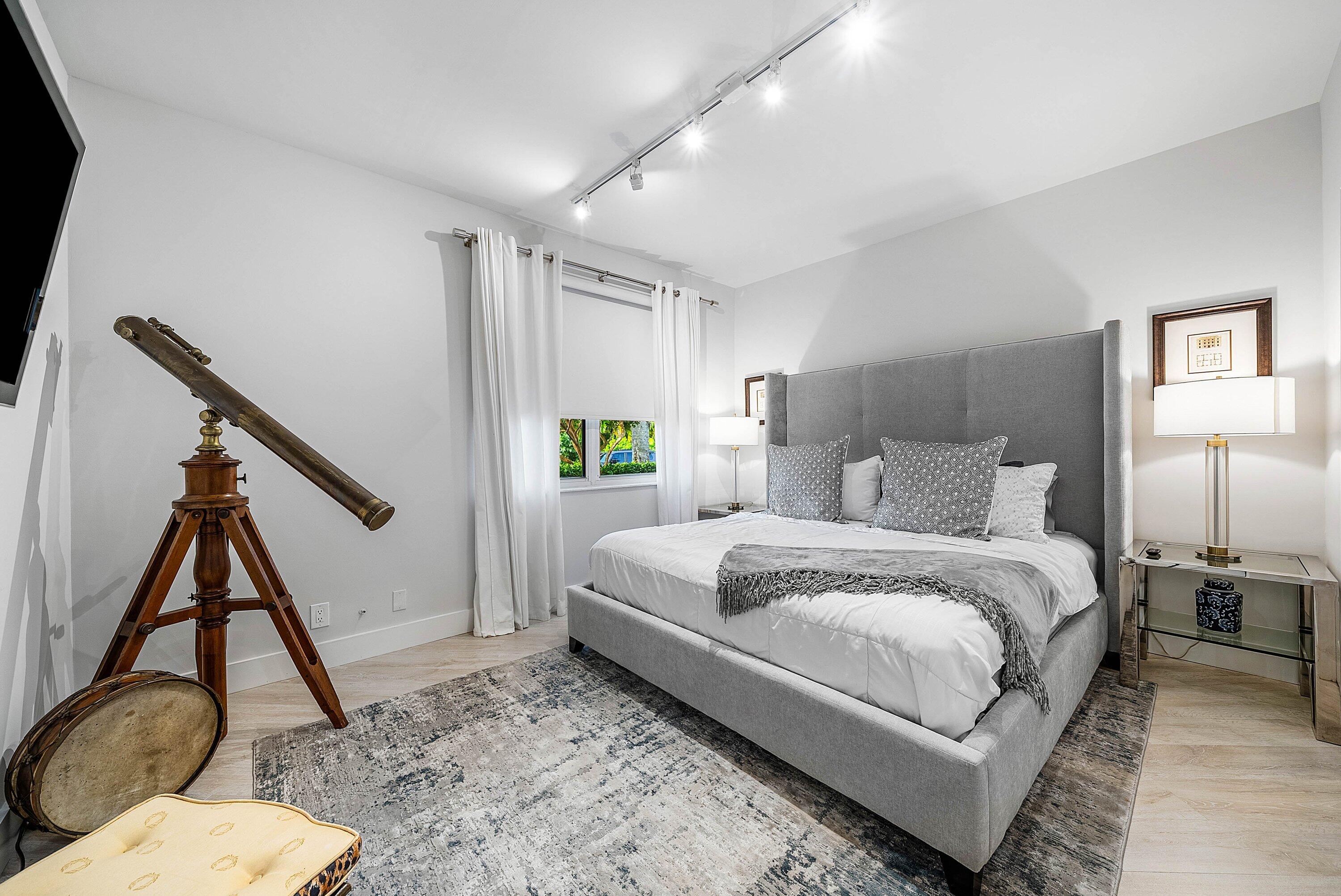 2224 Northwest 62nd Drive Boca Raton, FL 33496 - Photo 25 of 64 a spacious bedroom with a bed and a window