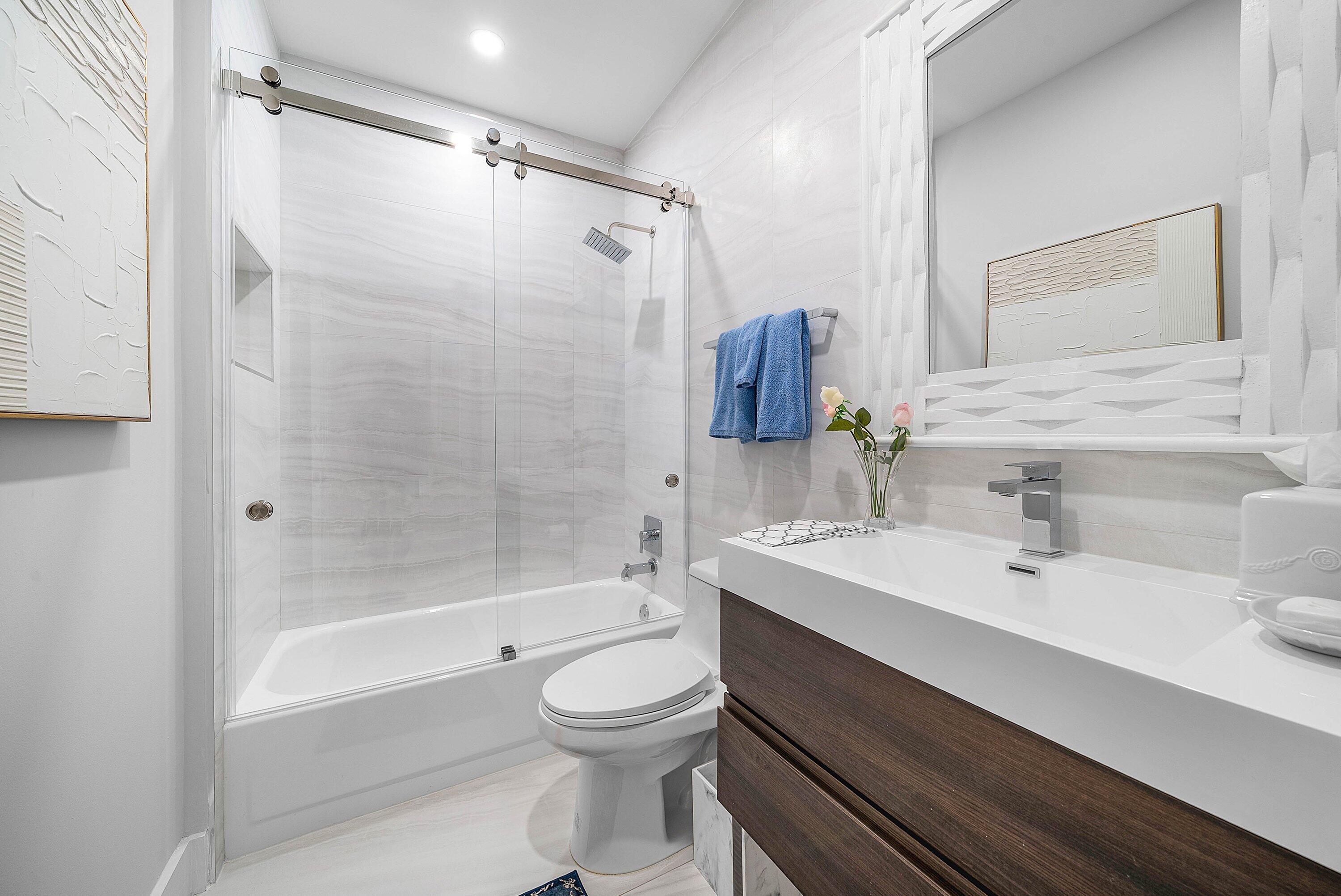 2224 Northwest 62nd Drive Boca Raton, FL 33496 - Photo 26 of 64 a bathroom with a sink a toilet and shower