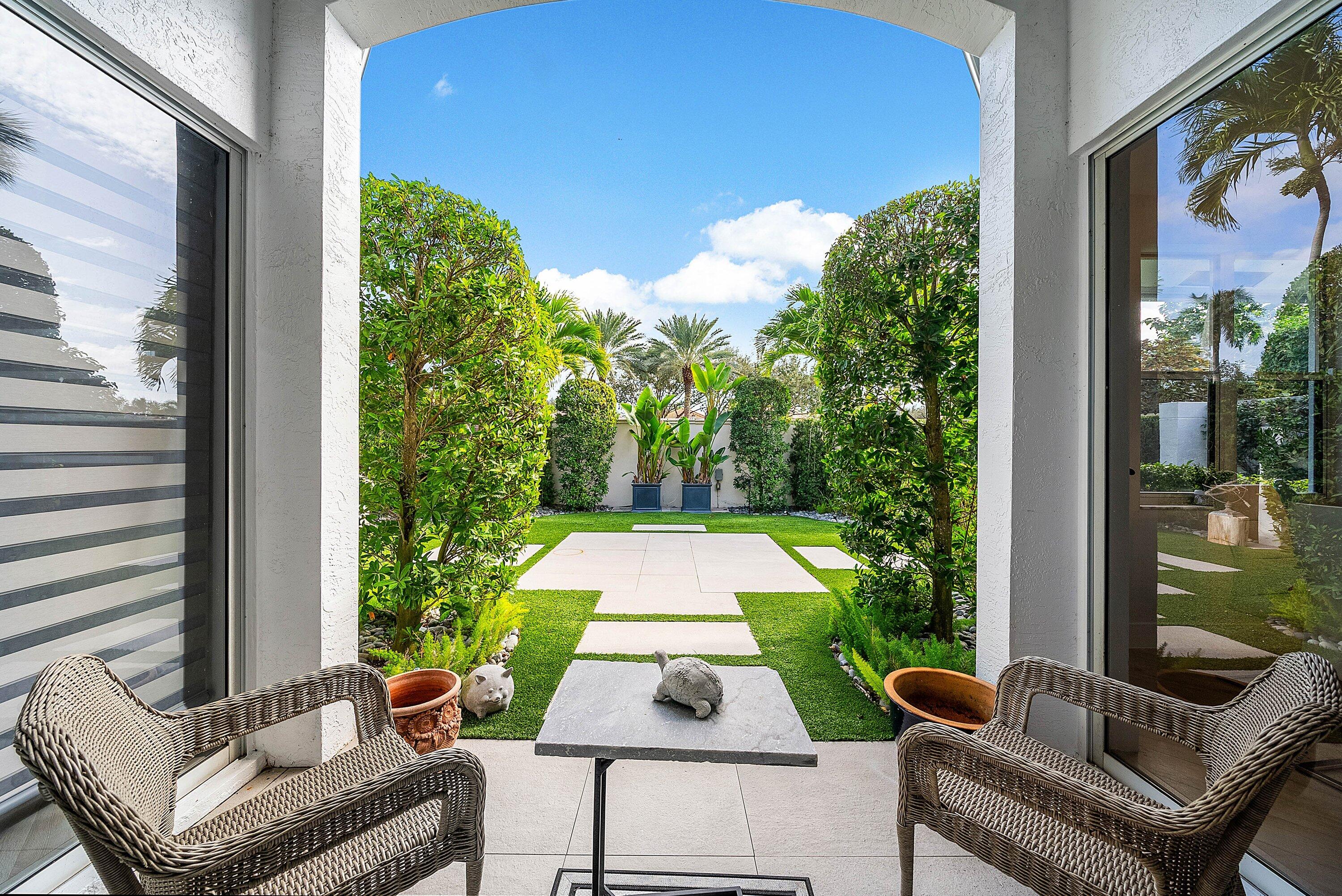 2224 Northwest 62nd Drive Boca Raton, FL 33496 - Photo 27 of 64 a view of a patio with couches table and chairs and potted plants
