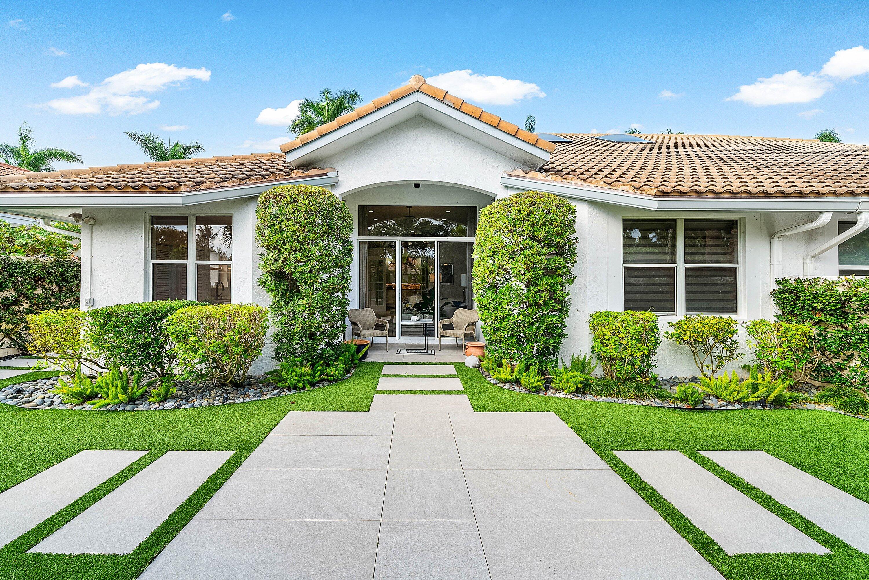 2224 Northwest 62nd Drive Boca Raton, FL 33496 - Photo 30 of 64 a front view of a house with a yard